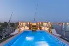 Merit Dahabiya I  Sun loungers on upper deck overlooking lush Nile landscapes on Merit Dahabiya